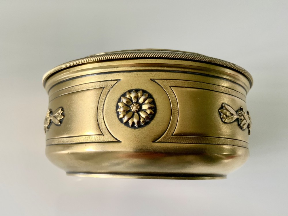 Top view of a round French vermeil silver covered bowl featuring relief carvings of floral rosettes and laurel foliage swags. View III