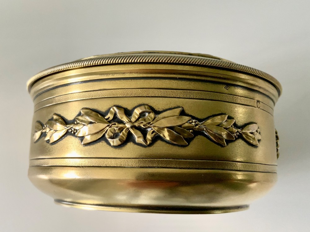 Top view of a round French vermeil silver covered bowl featuring relief carvings of floral rosettes and laurel foliage swags. View IV