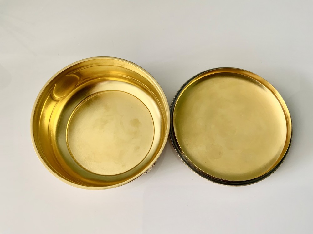 Top view of a round French vermeil silver covered bowl featuring relief carvings of floral rosettes and laurel foliage swags. View VI