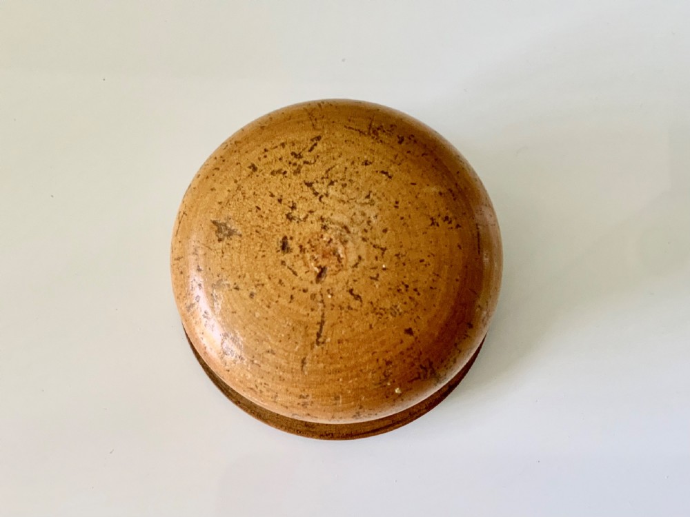A circular 19th-century turned wooden box featuring a lid with a topographical print of the Brighton Chain Pier framed by a sawtooth border. View III