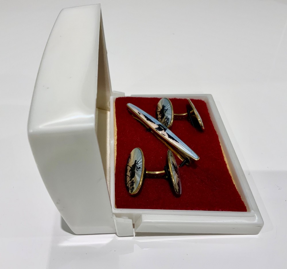 A set of oval silver and enamel cufflinks and a matching tie clip featuring a Viking longship design in blue and white guilloche enamel. View II