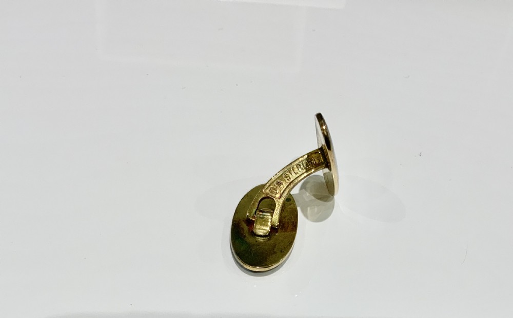 A set of oval silver and enamel cufflinks and a matching tie clip featuring a Viking longship design in blue and white guilloche enamel. View V