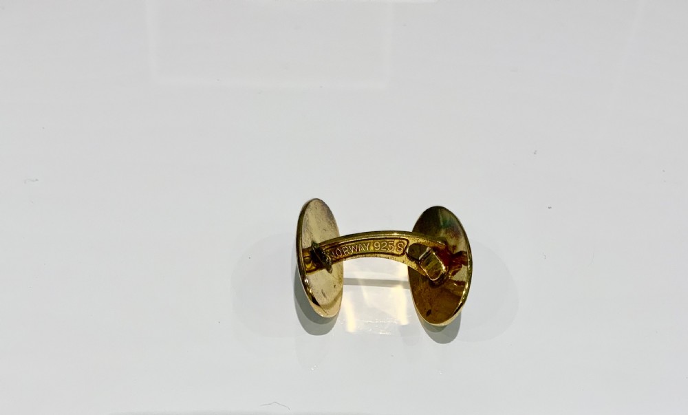 A set of oval silver and enamel cufflinks and a matching tie clip featuring a Viking longship design in blue and white guilloche enamel. View VI