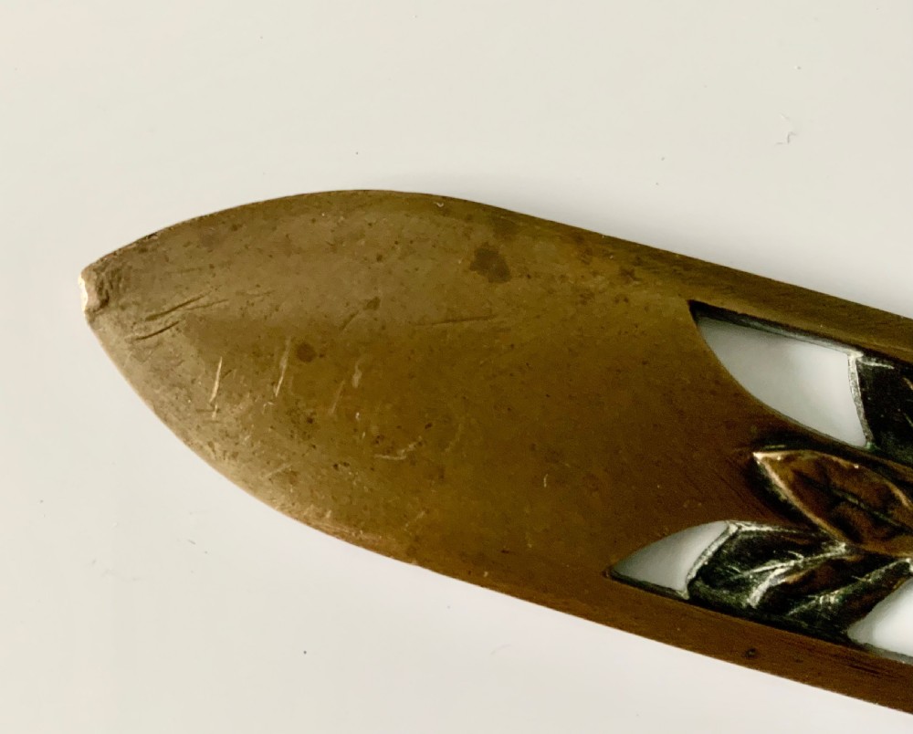 A French gilt bronze letter opener featuring pierced leaf motifs and a sculpted foliage handle. View VII