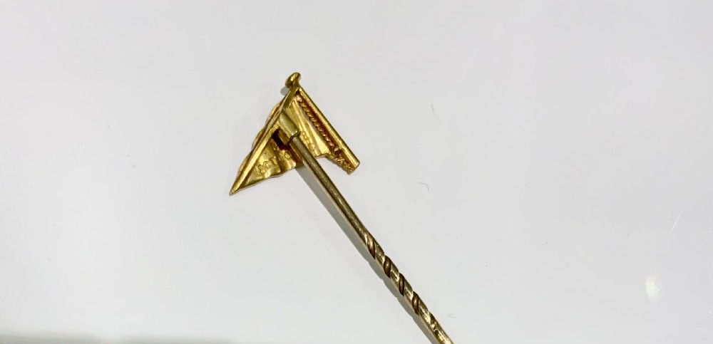 An 18ct yellow gold stick pin featuring a red enamelled yacht club burgee flag with a gold crown, anchor motif, and twisted stem. View III