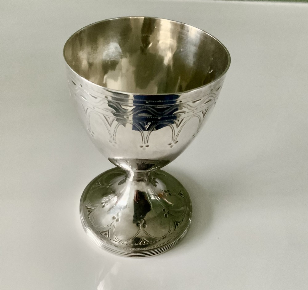 A Georgian silver goblet featuring bright-cut engraved geometric patterns on a circular pedestal foot and rounded bowl.