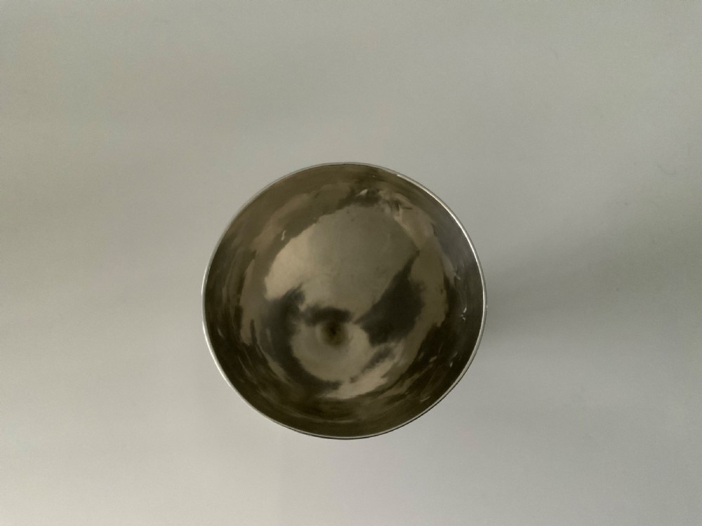A Georgian silver goblet featuring bright-cut engraved geometric patterns on a circular pedestal foot and rounded bowl. View III