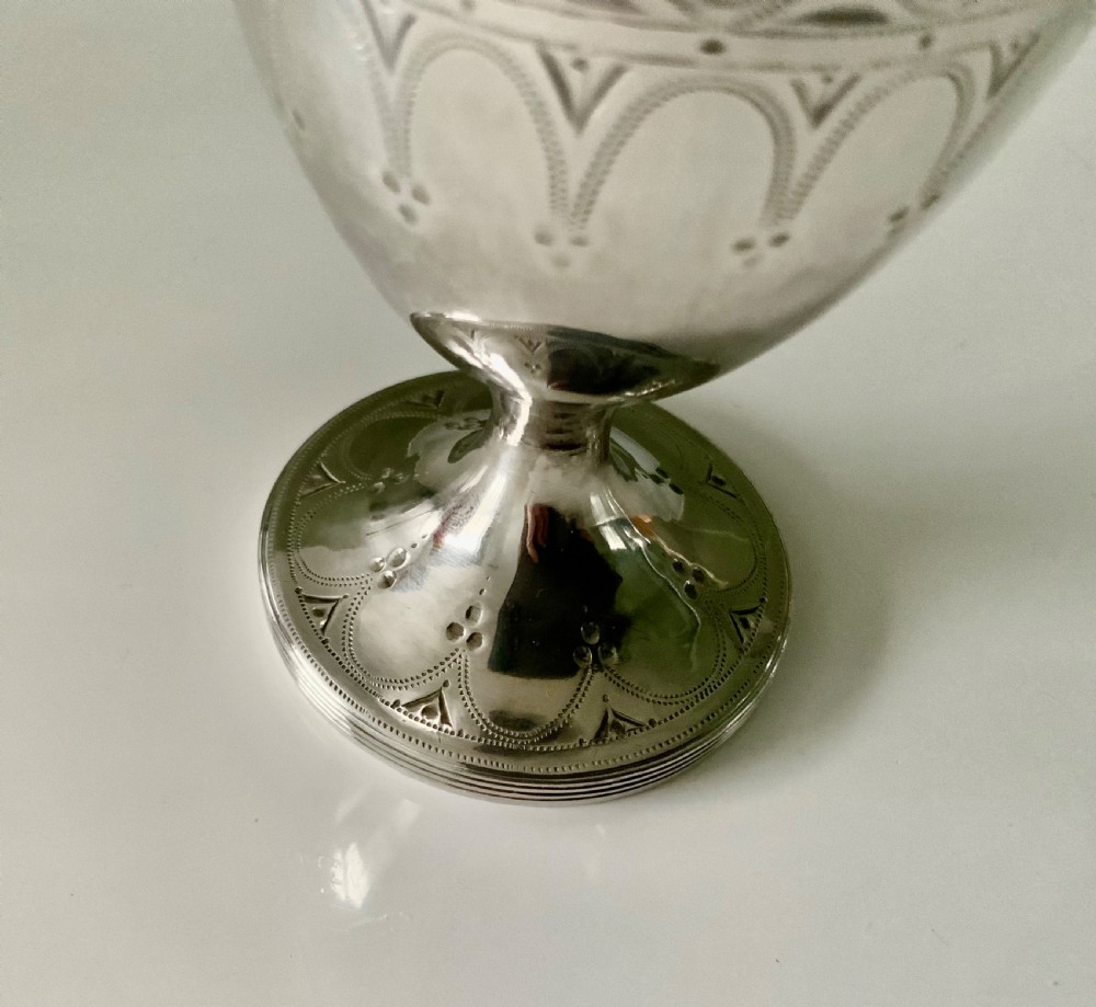 A Georgian silver goblet featuring bright-cut engraved geometric patterns on a circular pedestal foot and rounded bowl. View V