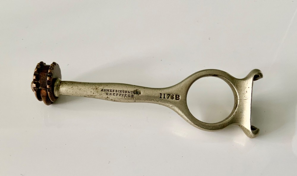An antique Victorian brass and steel Popes patent cartridge case extractor with stamped maker details and a cogged head. View II