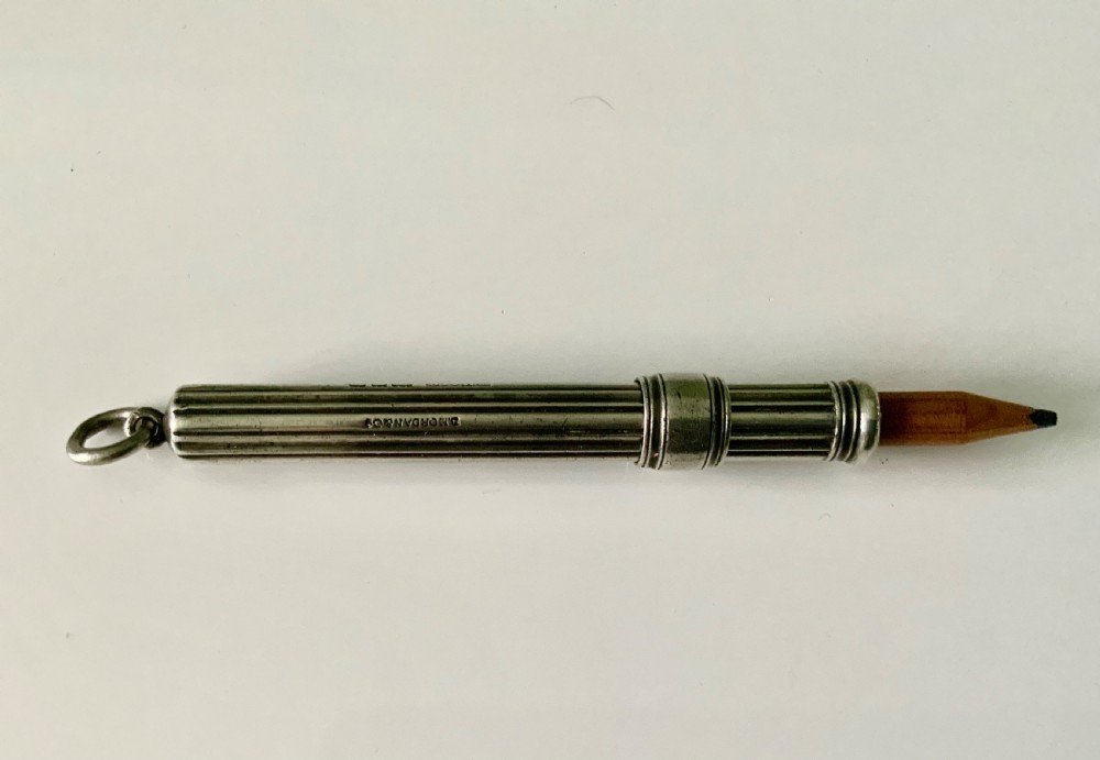A Victorian fluted sterling silver sliding pencil featuring hallmark stamps and a top suspension ring. View II