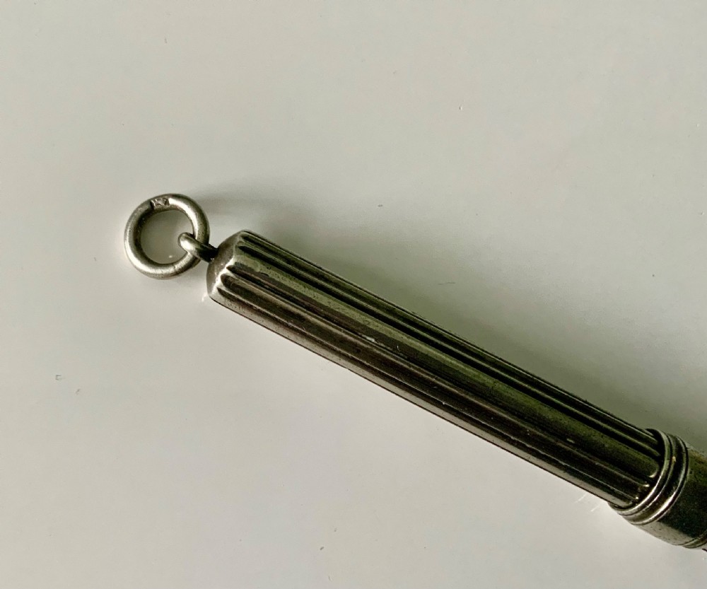 A Victorian fluted sterling silver sliding pencil featuring hallmark stamps and a top suspension ring. View III