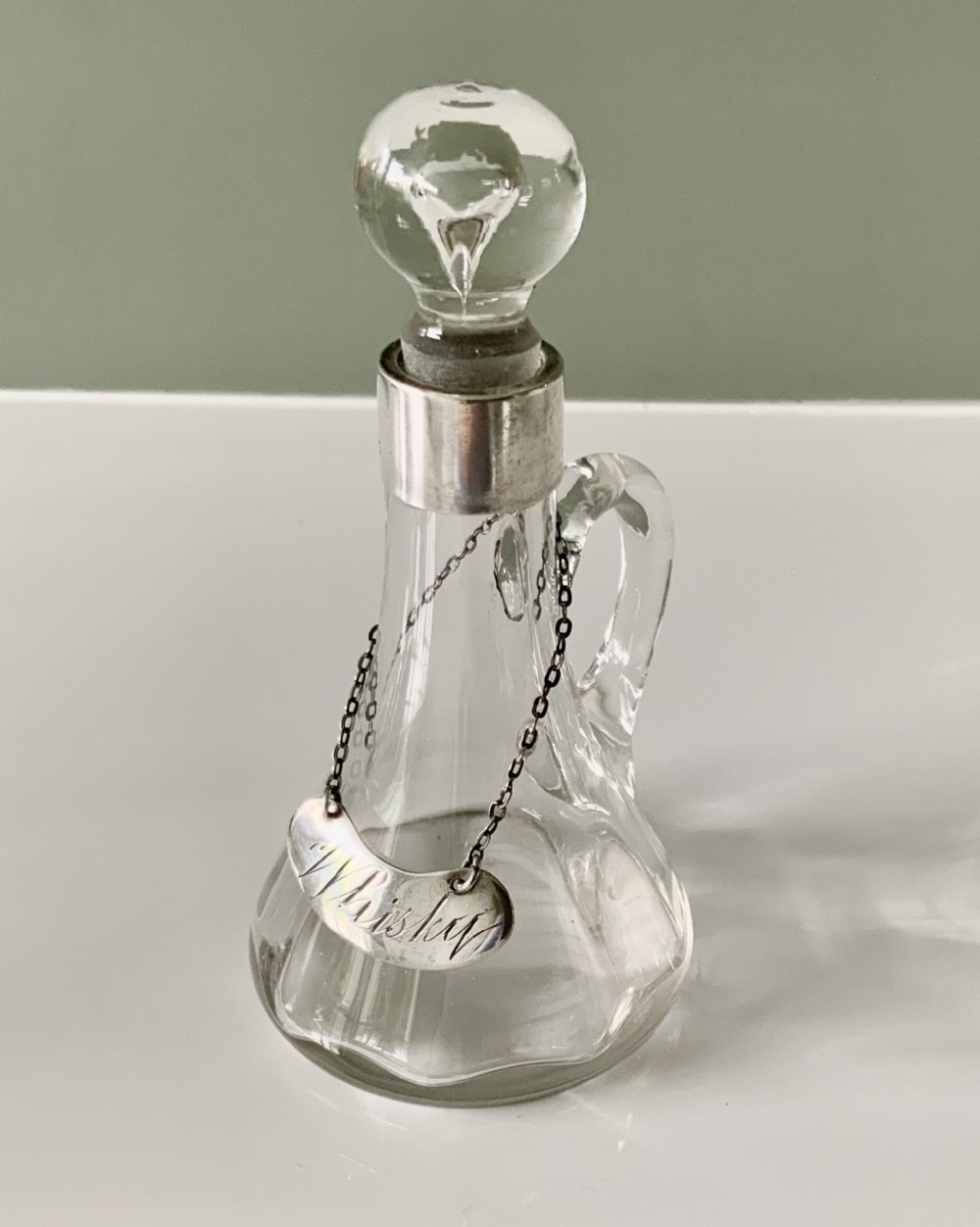 Silver mounted Whisky noggin with label