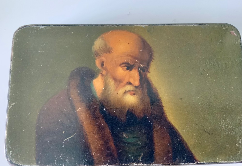 An early 19th-century rectangular painted tin snuff box featuring a hand-painted portrait of a bearded man on the olive green lid. View II