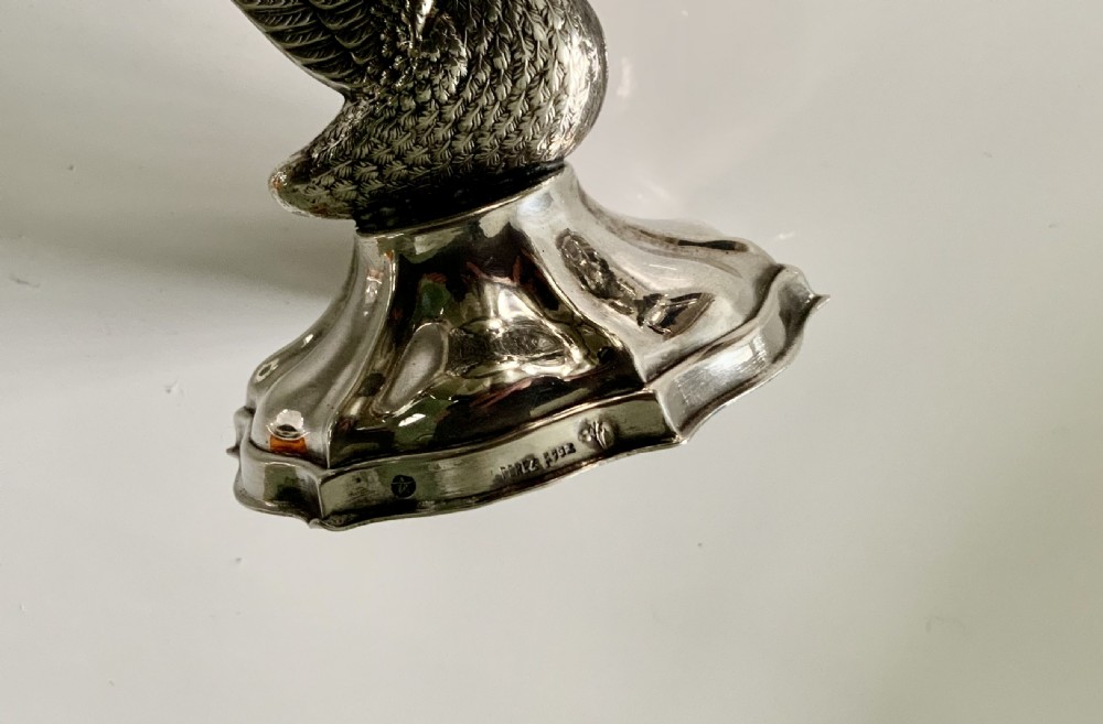 A polished silver dish featuring a lobed rim, two ornate scroll handles, and a central swan motif on a flared pedestal base. View IV