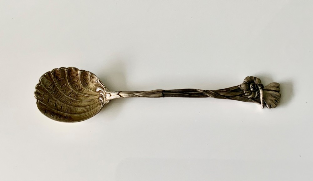 A set of six Art Nouveau silver teaspoons with shell bowls and floral stems, displayed inside an open fitted cloth-lined presentation box. View V