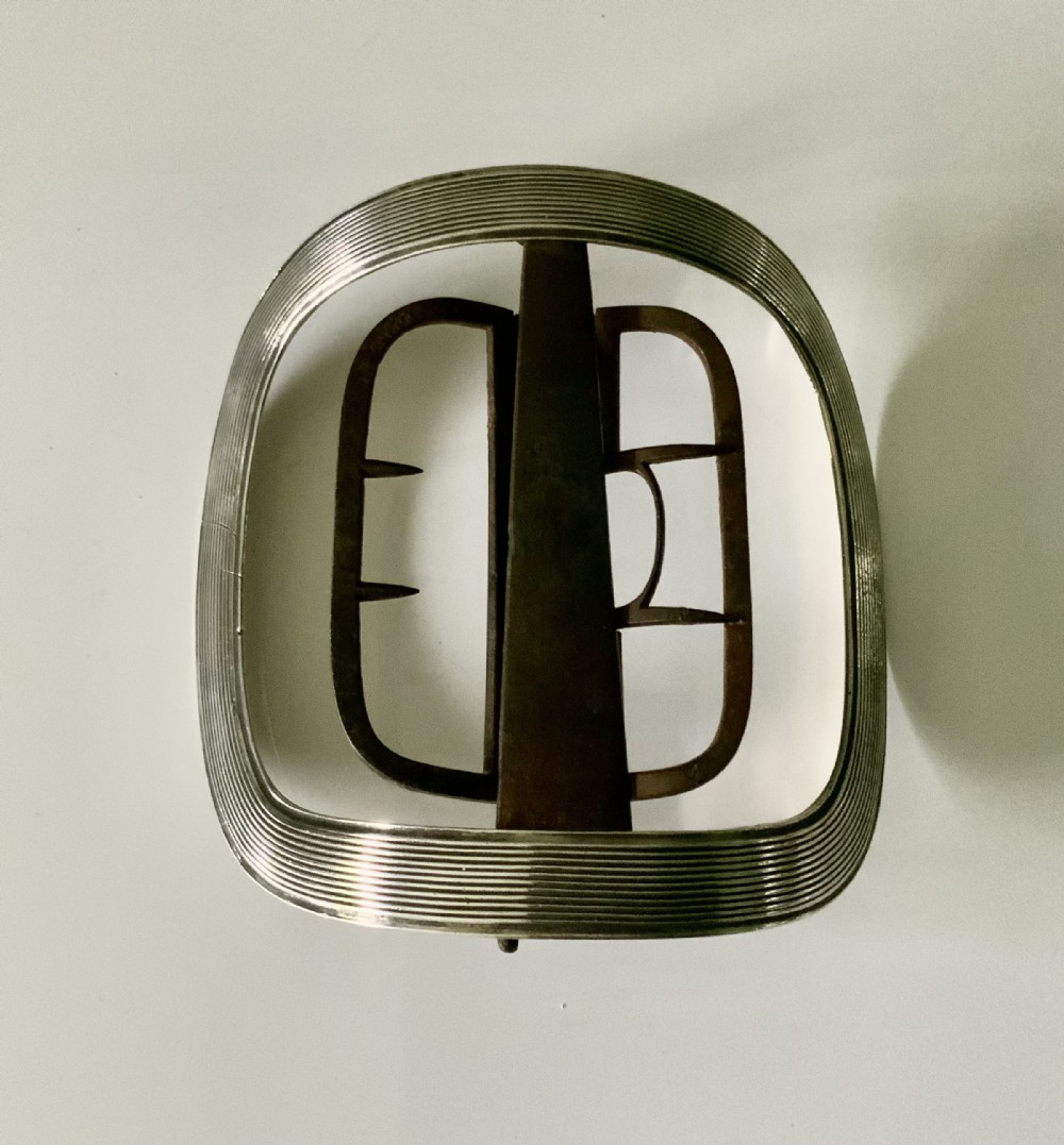 A curved rectangular Georgian silver shoe buckle featuring a grooved outer frame and a hinged steel inner attachment mechanism.