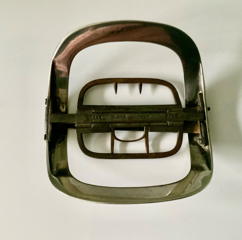 A curved rectangular Georgian silver shoe buckle featuring a grooved outer frame and a hinged steel inner attachment mechanism. View IV