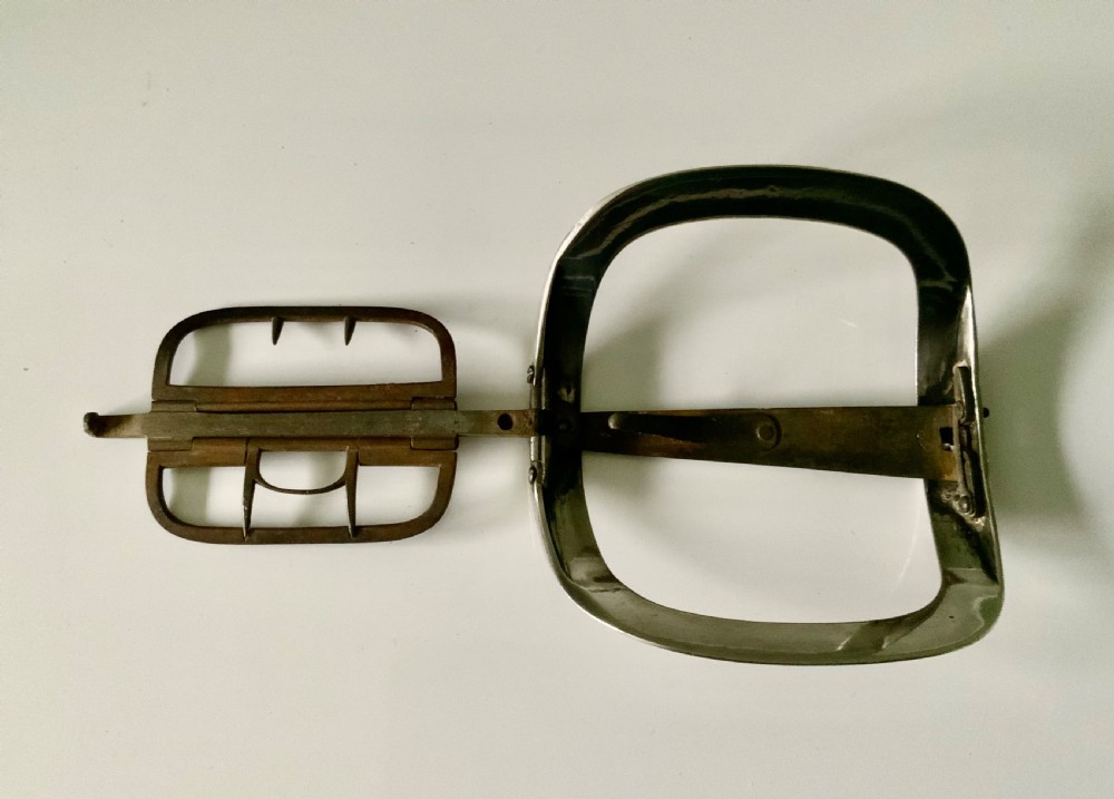 A curved rectangular Georgian silver shoe buckle featuring a grooved outer frame and a hinged steel inner attachment mechanism. View V
