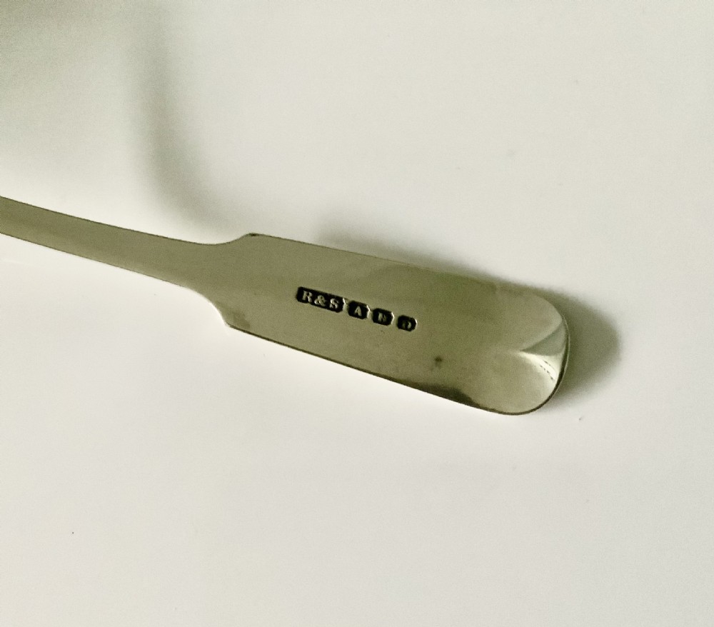 A silver toddy ladle featuring a rounded circular bowl and a fiddle pattern stem with engraved monogram initials. View III