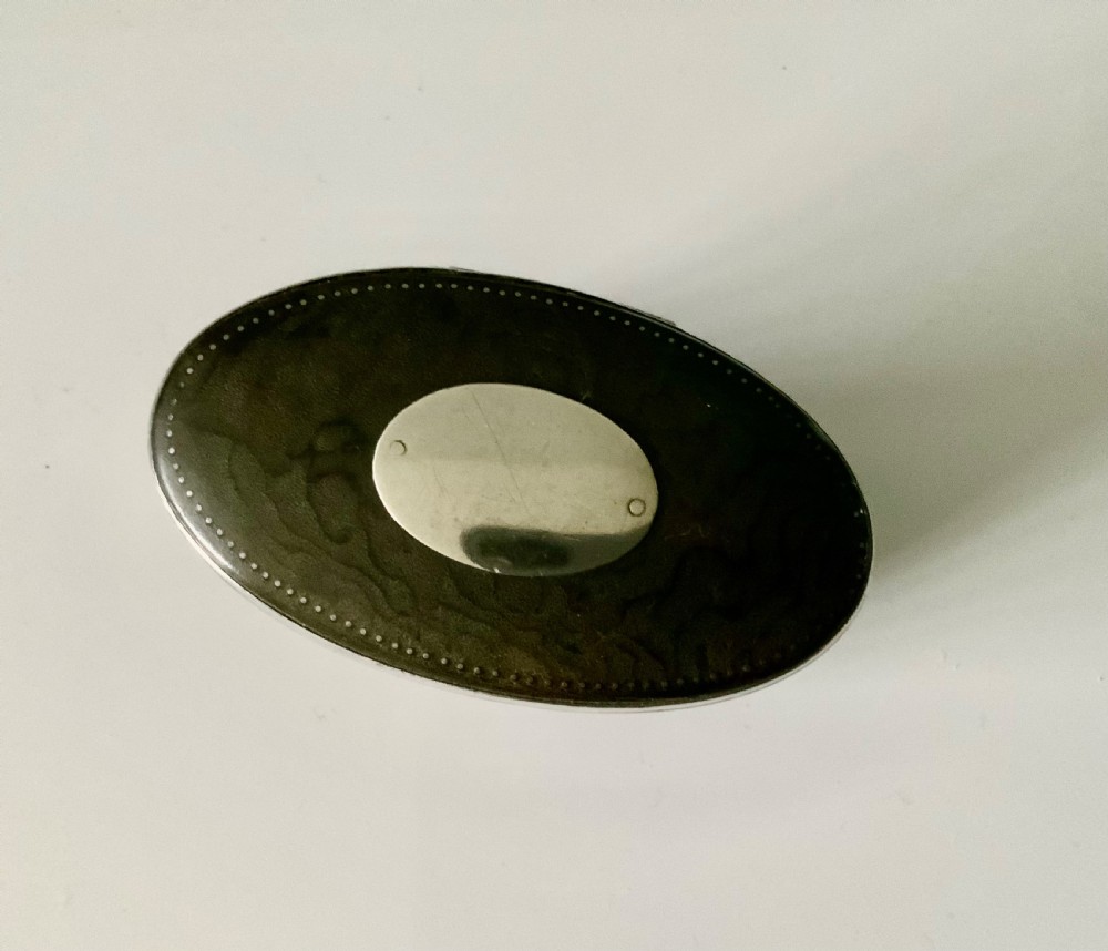 An oval antique Scottish snuff mull with a dark horn body and a fitted silver-mounted lid featuring an inset blank shield. View IV