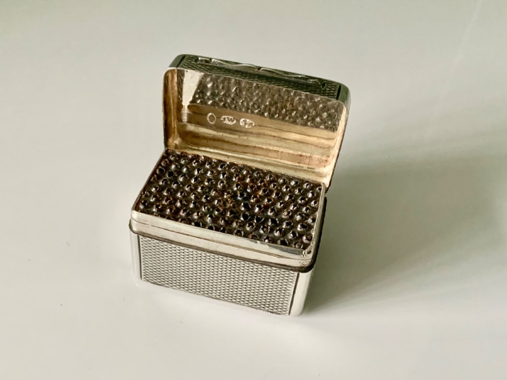 A small rectangular William IV sterling silver nutmeg grater featuring engine-turned surface patterns and a central cartouche engraved with initials. View III