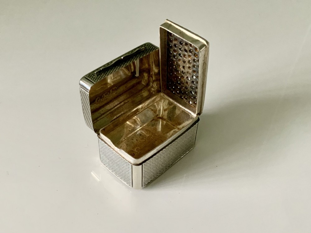 A small rectangular William IV sterling silver nutmeg grater featuring engine-turned surface patterns and a central cartouche engraved with initials. View IV