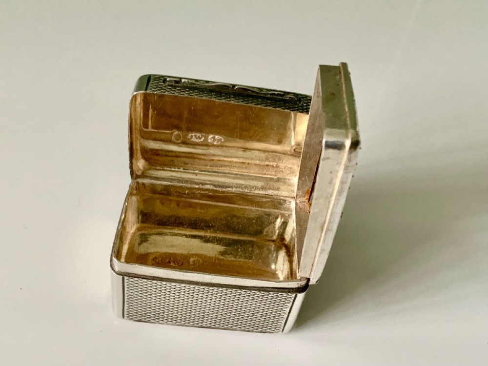 A small rectangular William IV sterling silver nutmeg grater featuring engine-turned surface patterns and a central cartouche engraved with initials. View V