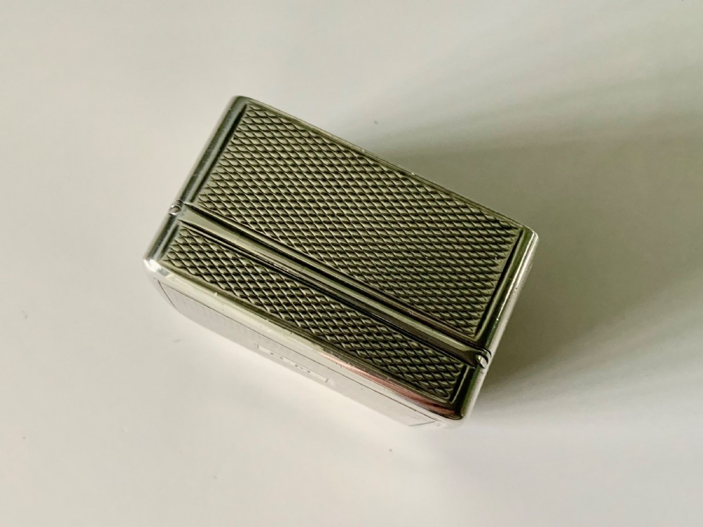 A small rectangular William IV sterling silver nutmeg grater featuring engine-turned surface patterns and a central cartouche engraved with initials. View VII