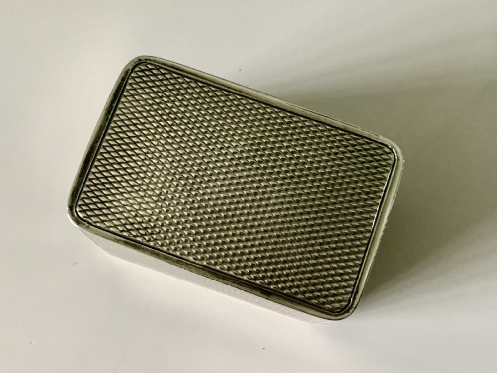 A small rectangular William IV sterling silver nutmeg grater featuring engine-turned surface patterns and a central cartouche engraved with initials. View VIII