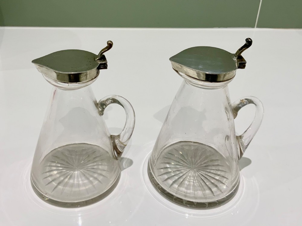 A pair of conical clear glass whisky noggins with star-cut bases and hallmarked sterling silver hinged lids. View III