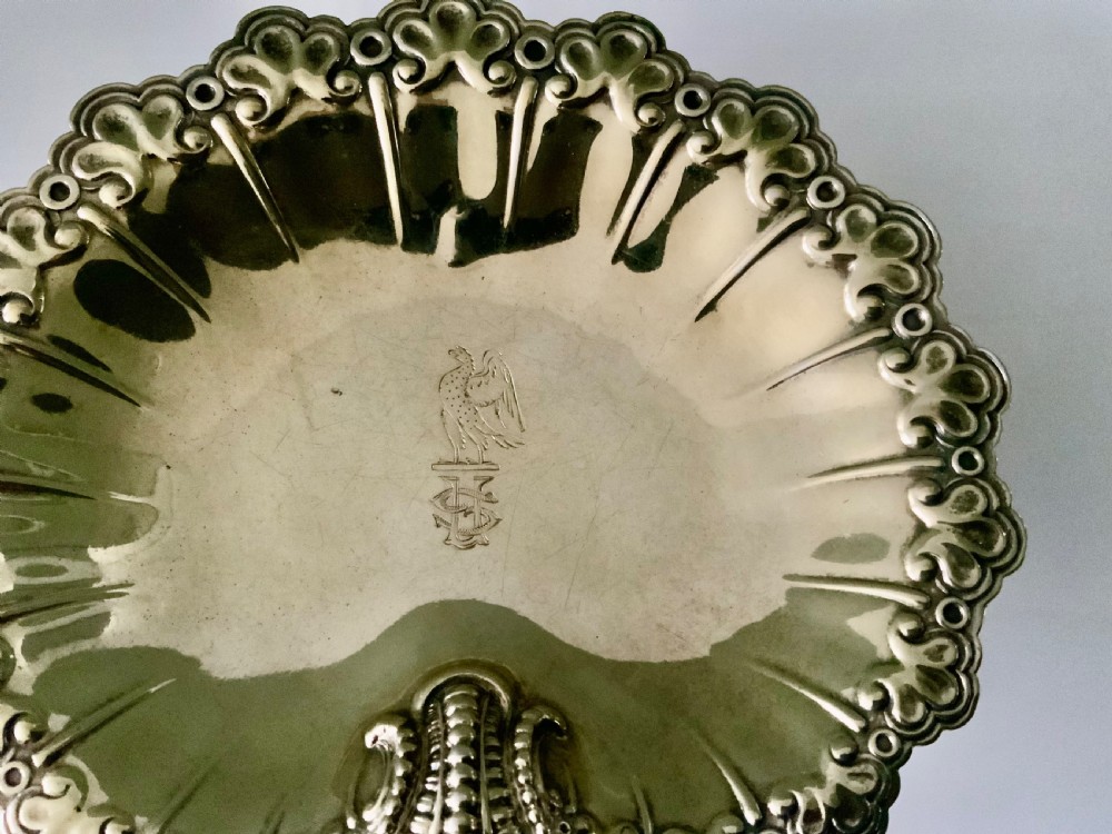 A Victorian shell-shaped silver-gilt dish with lobed fluting, a scalloped scroll rim, and an engraved crest at the centre. View II