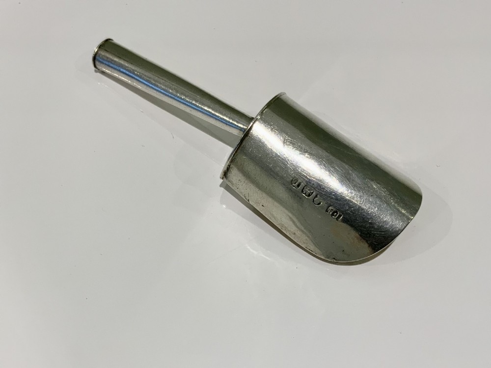 A Georgian silver shovel-form caddy spoon featuring a turned cylindrical handle and a gilt-lined scoop bowl. View IV