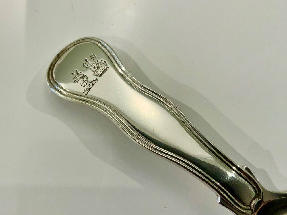 An antique Georgian sterling silver caddy spoon featuring a broad smooth bowl and a short moulded double struck handle. View III