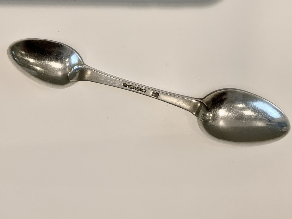 An antique Victorian double-ended silver medicine spoon featuring a small oval bowl at one end and a larger bowl at the opposite end. View II