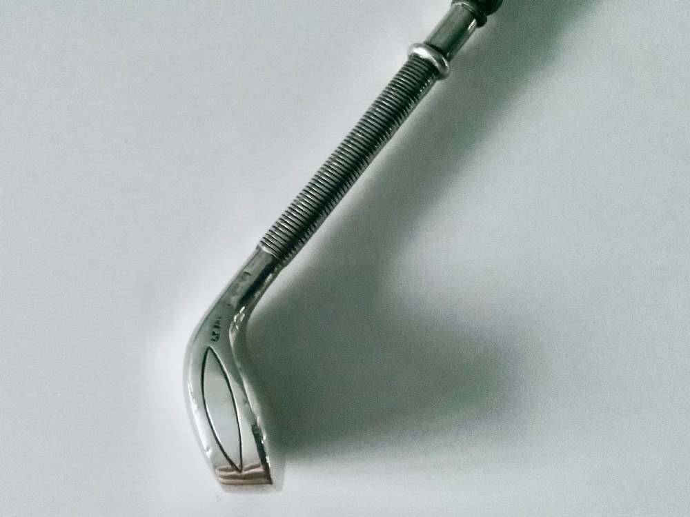 A sterling silver button hook featuring a handle shaped like a golf club head with a textured grip. View II