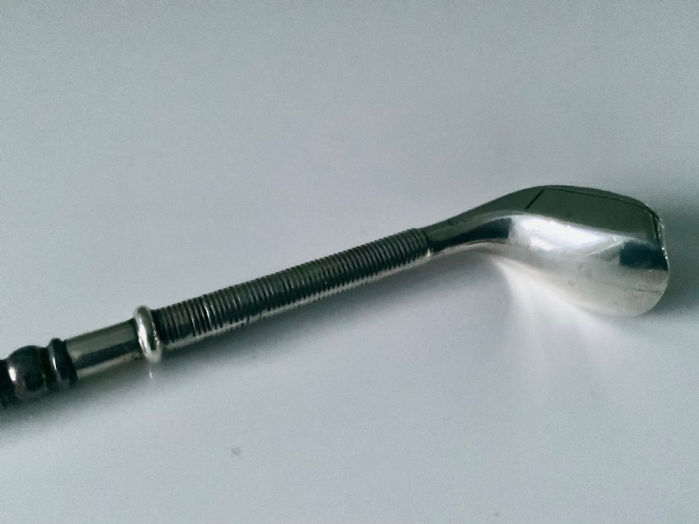 A sterling silver button hook featuring a handle shaped like a golf club head with a textured grip. View V