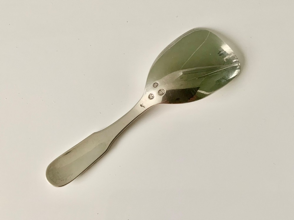 A sterling silver caddy spoon with a wide shovel-shaped bowl and a tapered handle featuring beaded relief edging. View II