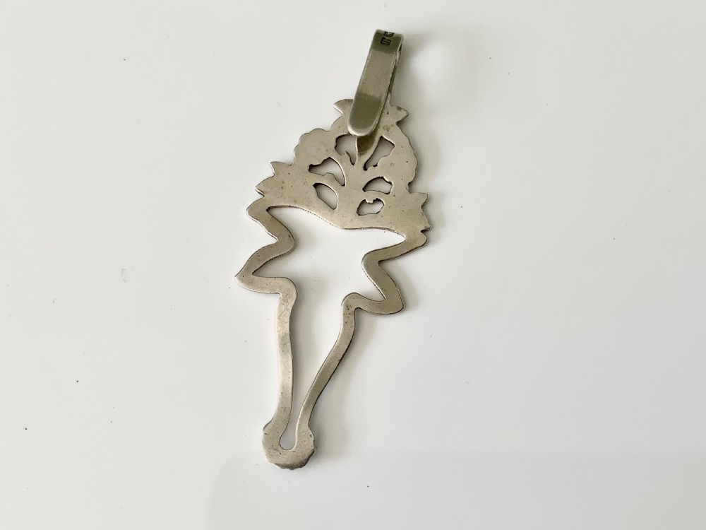 An antique silver napkin clip featuring floral repousse ornamentation and a top hook stamped with a maker mark. View II