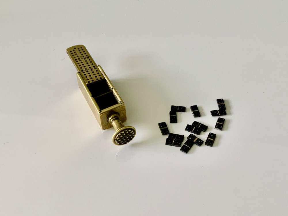 A nineteenth-century cast brass pipe tamper featuring a rectangular miniature cribbage scoring board connected to a turned pedestal handle. View IV
