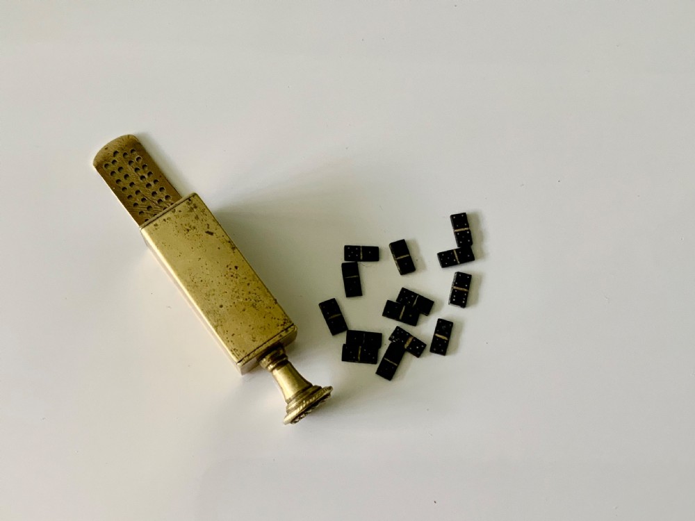 A nineteenth-century cast brass pipe tamper featuring a rectangular miniature cribbage scoring board connected to a turned pedestal handle. View V