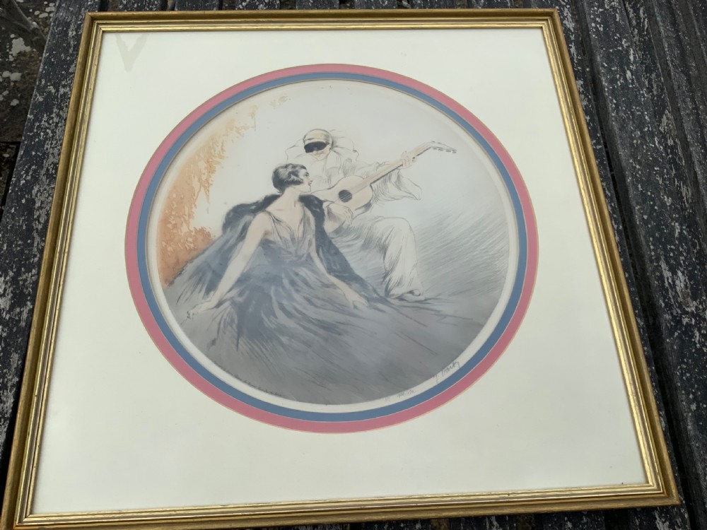 A circular Art Deco lithograph by Jean Hardy depicting a seated woman and a masked guitar player, mounted inside a square gilded frame.