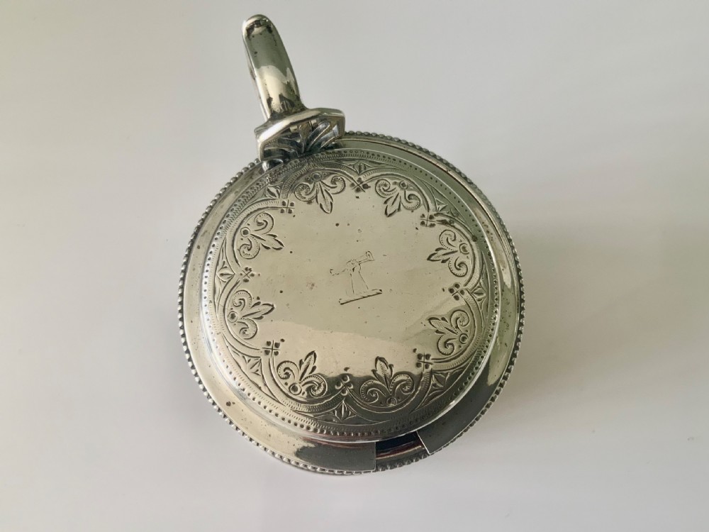 A pierced silver mustard pot with an engraved hinged lid, beaded rims, and a visible ruby red glass liner. View II