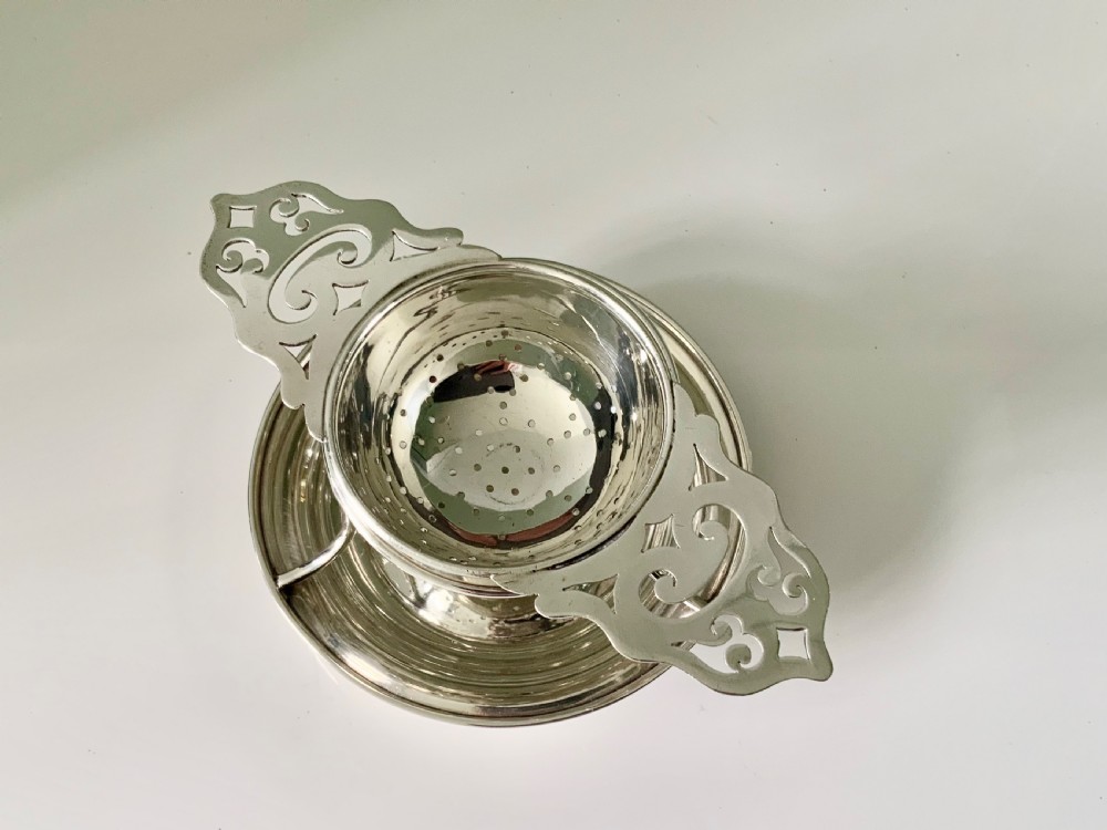 Silver tea strainer & stand Walker & Hall View II
