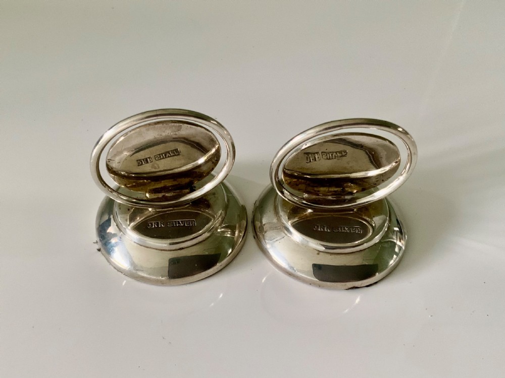 A pair of circular silver menu holders with stepped round bases and engraved coronet monograms. View III