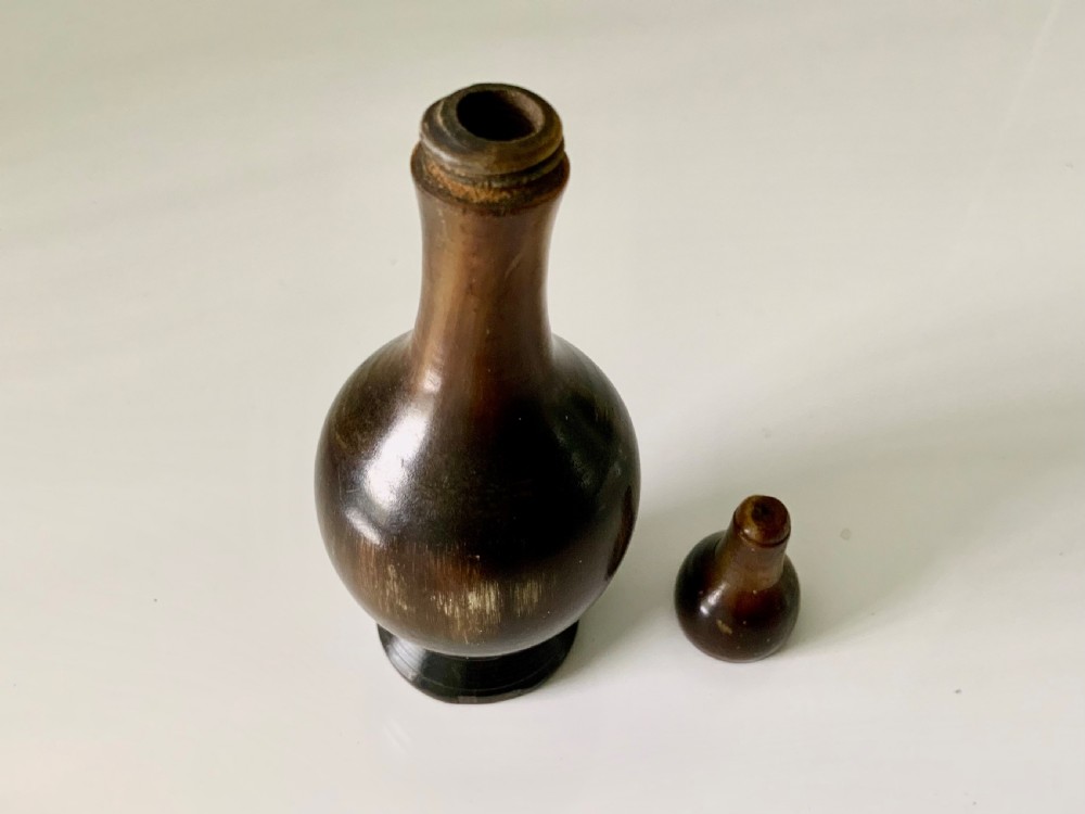 A 19th-century turned horn glove powderer featuring a rounded bulbous base, a narrow neck, and a polished dark brown finish. View II