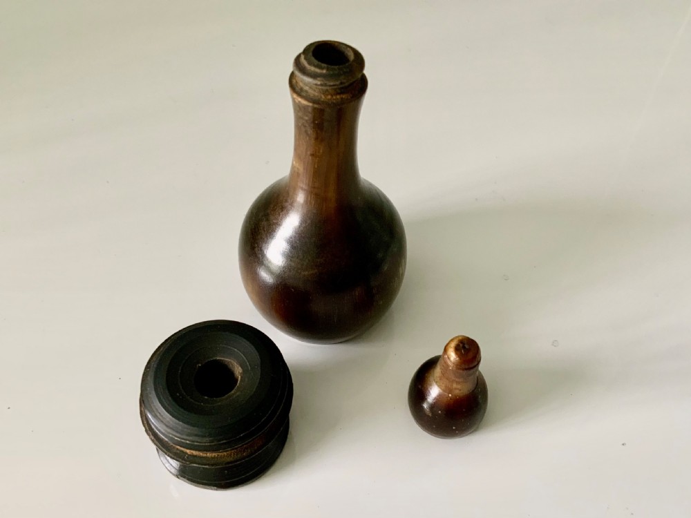 A 19th-century turned horn glove powderer featuring a rounded bulbous base, a narrow neck, and a polished dark brown finish. View III