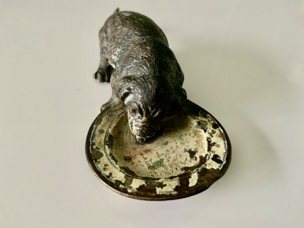 An antique Austrian cold-painted bronze sculpture depicting a small dog drinking from a shallow round bowl with remaining original paint. View III