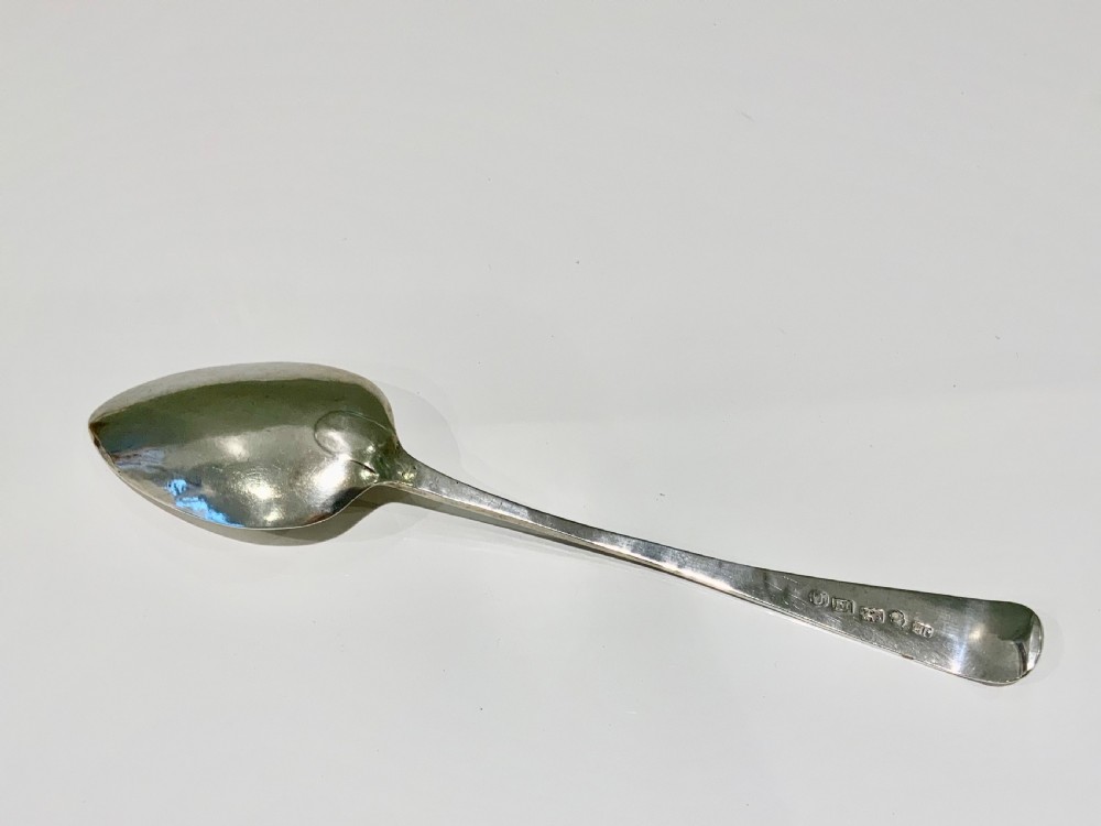 A Georgian sterling silver spoon featuring bright-cut hand engraving along the stem and an engraved monogram on the terminal. View II