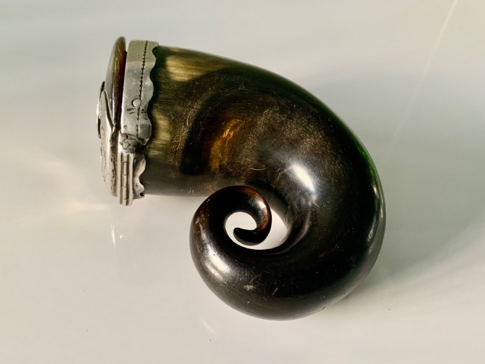 A nineteenth-century Scottish horn snuff mull featuring a curled natural horn body topped with engraved silver mounts and a hinged lid. View II