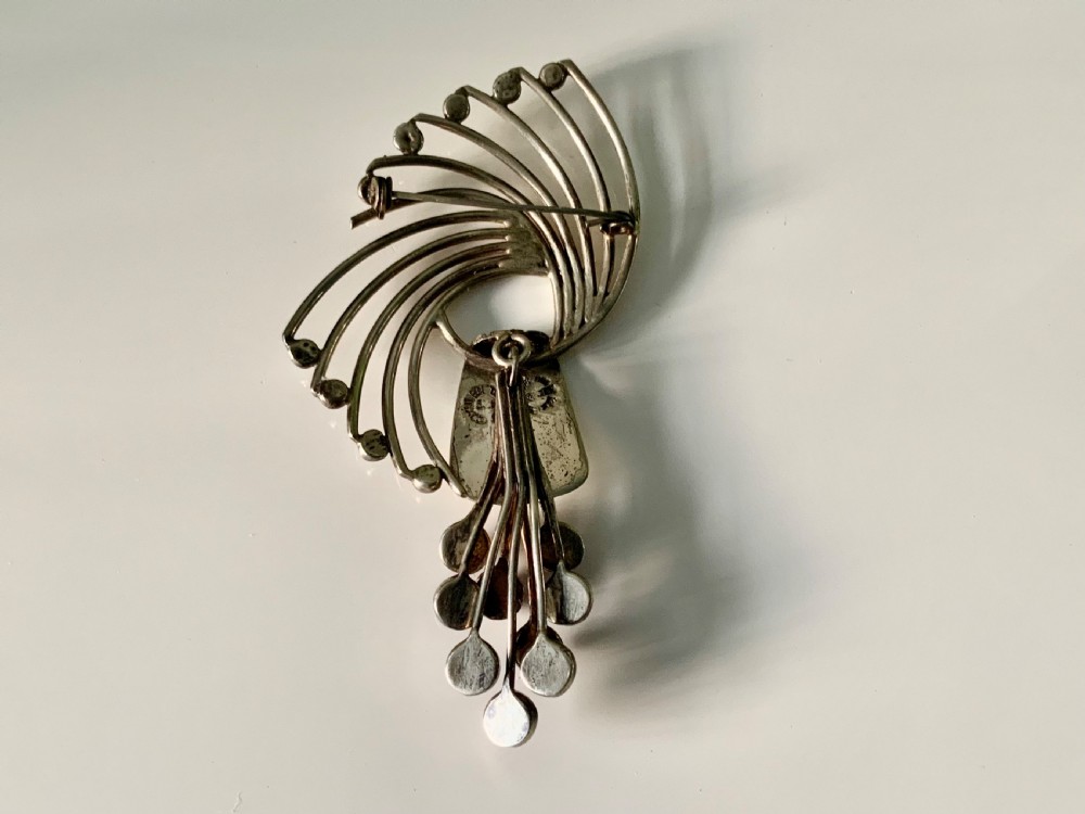 A Mexican sterling silver brooch designed with sweeping curved wires and hanging purple amethyst cabochons. View III